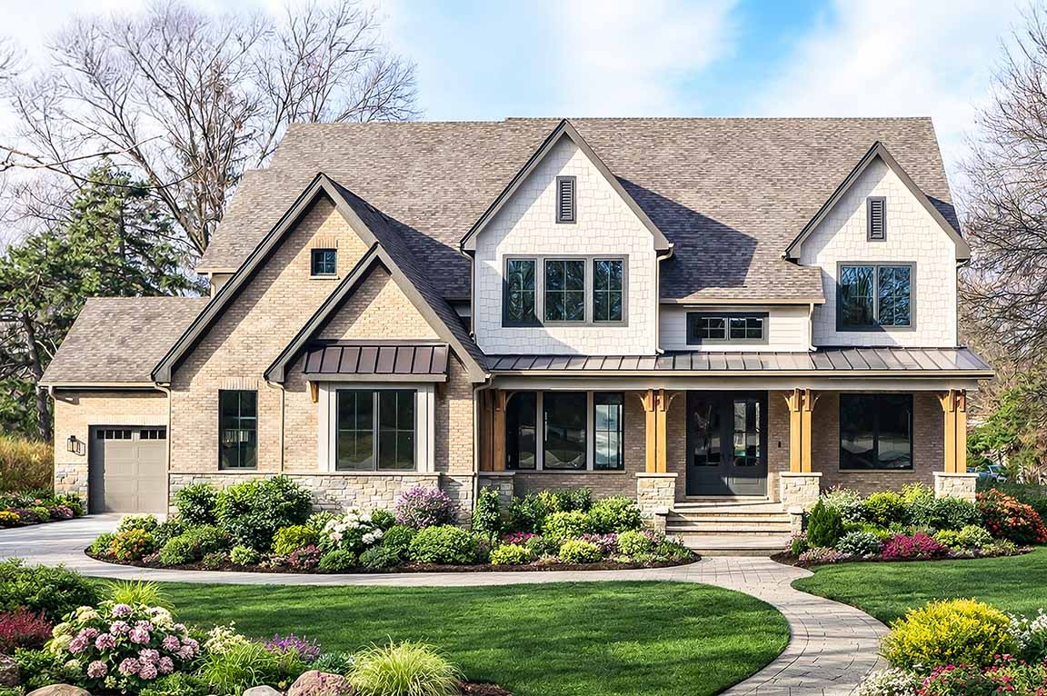 Modern farmhouse home exterior with brick siding, gabled roof, covered porch, and landscaped front yard.