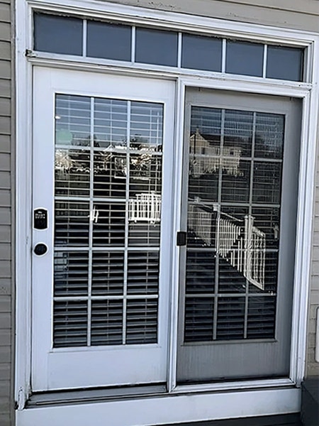 Image of an outdated patio door on a Whitehall home.