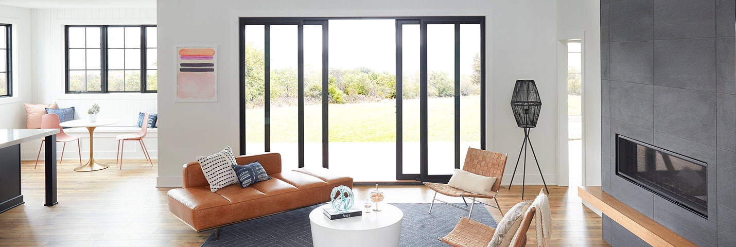contemporary living room with four panel sliding patio doors