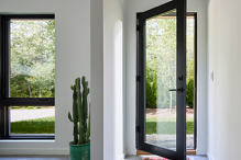 Pella Reserve fixed and casement windows on a white contemporary home exterior wall.