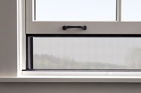 rolscreen integrated screen on a double-hung window