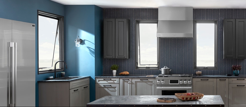 Tall awning windows light dark blue and gray kitchen