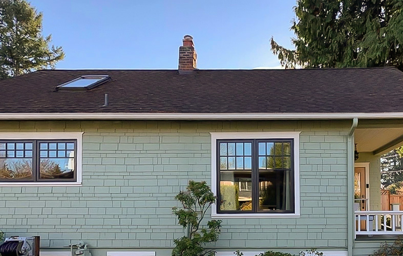 A craftsman-style home exterior side with new Pella wood casement windows