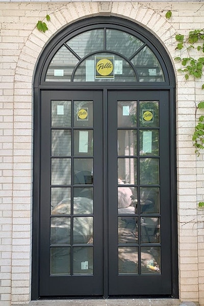 Pella French Doors with a matching arched transom on a white brick home exterior