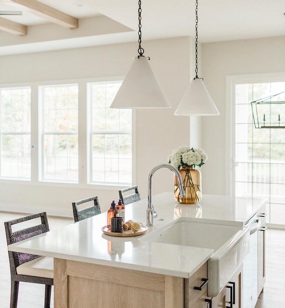 White double-hung windows and patio door in traditional kitchen.
