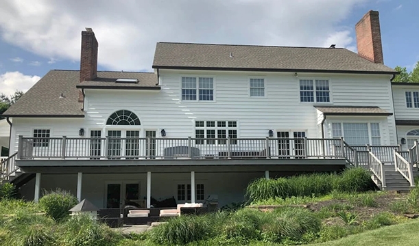 Backyard view of a New Hope colonial style home in need of modern updates.