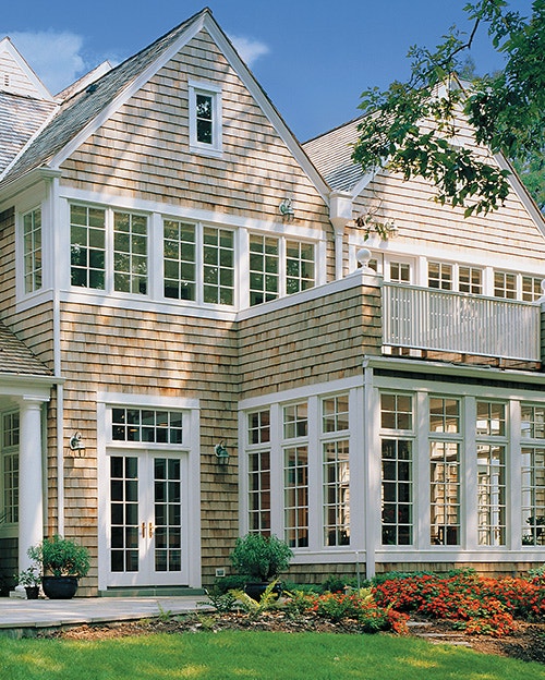 historic home with a sunroom and white wood architect series windows