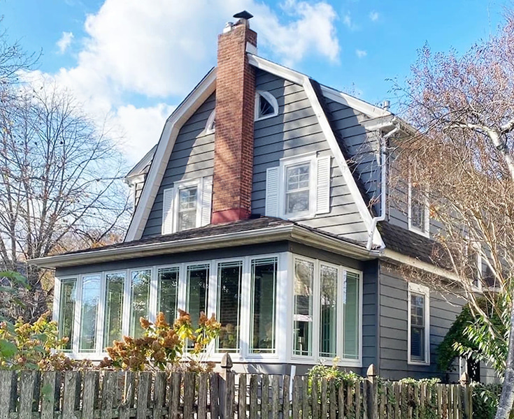 Exterior view of Haddonfield home highlighting sunroom with newly installed Pella triple-pane casement windows.