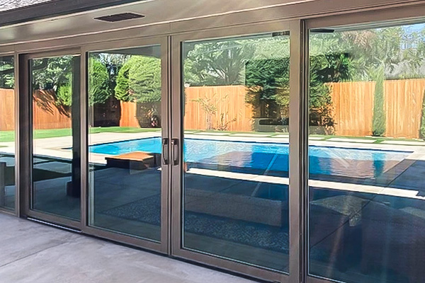 four-panel french sliding patio door reflecting a swimming pool