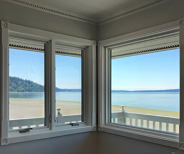 Two new sets of windows form the corner of a home with blue ocean views