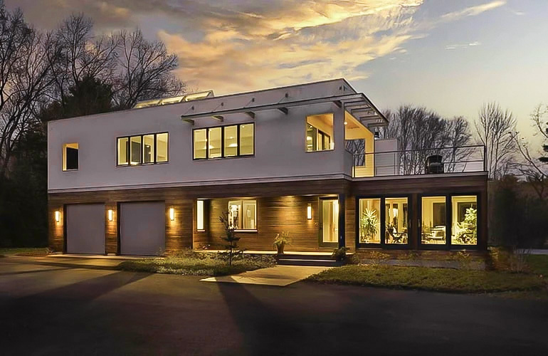 Weston, MA home exterior with new Pella windows and doors, taken at dusk