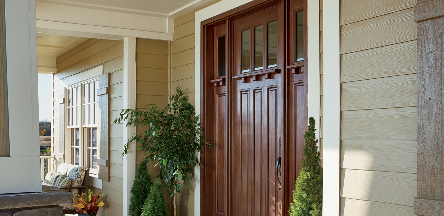 an angled view of a wood entry door with accessories