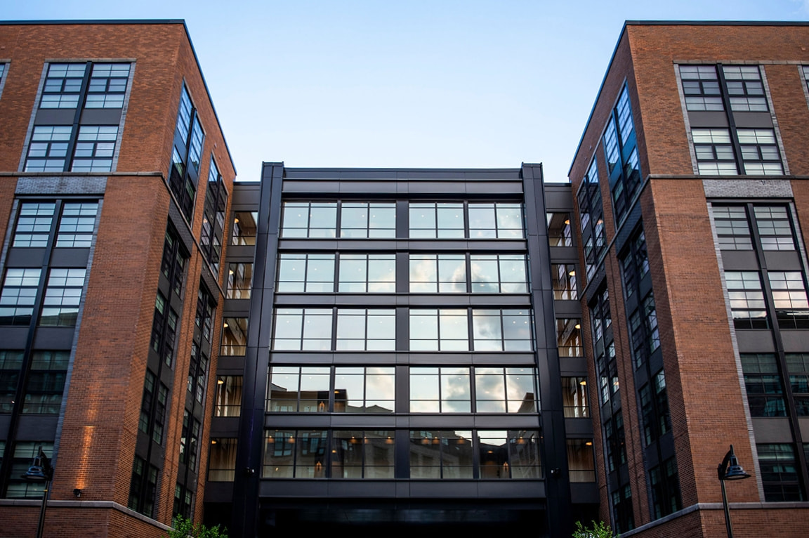A modern luxury apartment building with fiberglass picture windows. 
