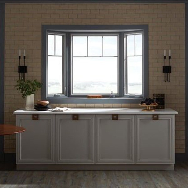 Modern dining room with a gray bay window with top grilles above the white counter