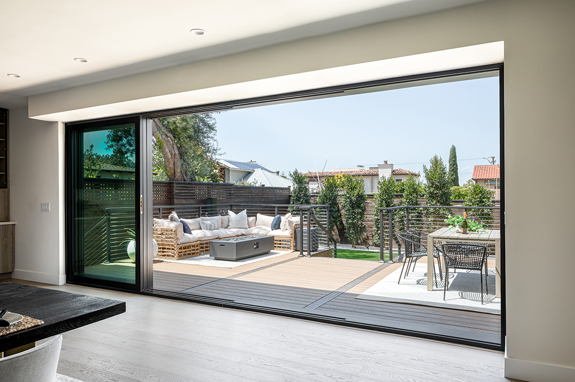 Interior view of open multi-slide patio door on La Jolla home.