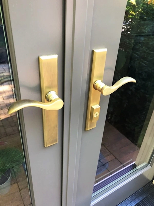 Gold colored french door hardware complementing custom gray Pella doors on Lancaster home. 
