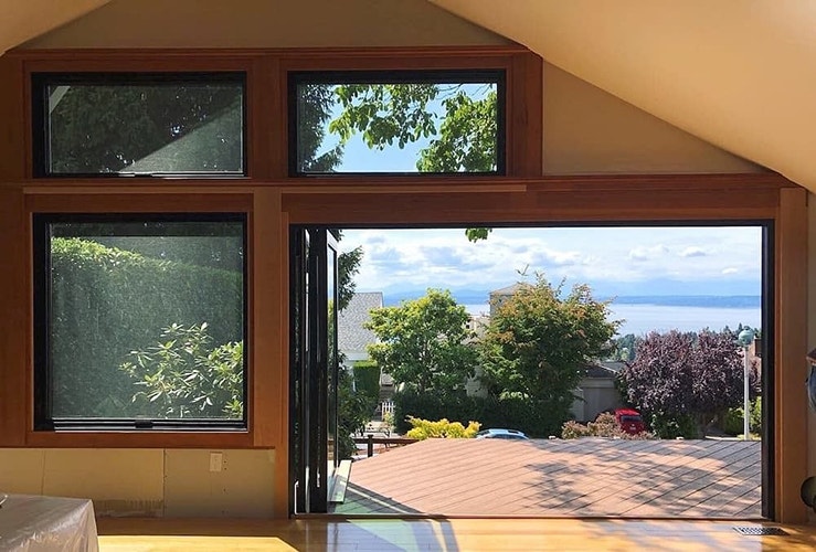 the bifold door is open and the northwestern skyline adds a lot of natural color