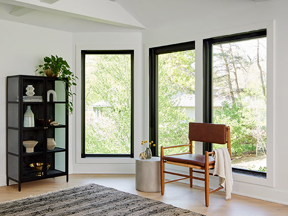 three tall casement windows on a white wall