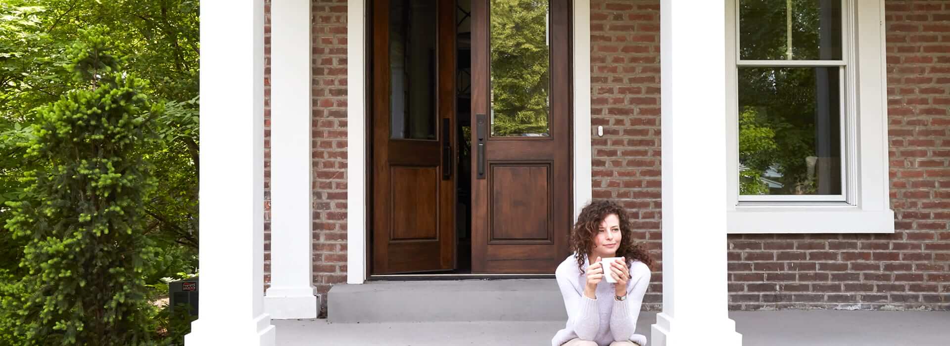 woman sitting on the porch of a home with weather resistant products