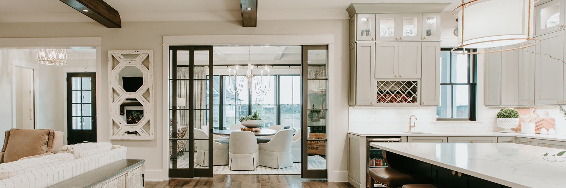 Modern home interior featuring Pella windows and sliding glass doors between kitchen and dining area