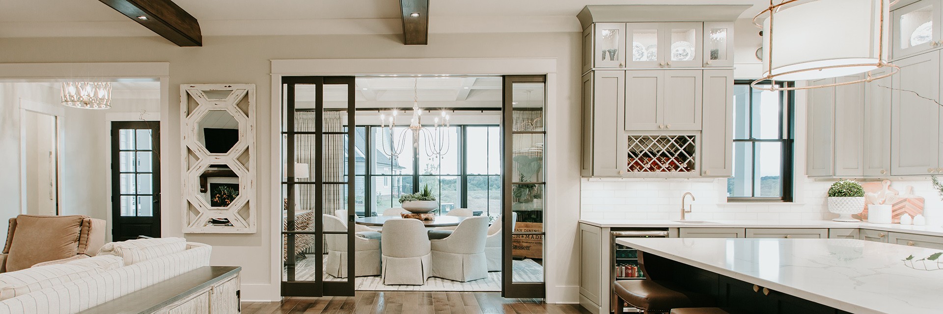 Modern home interior featuring Pella windows and sliding glass doors between kitchen and dining area