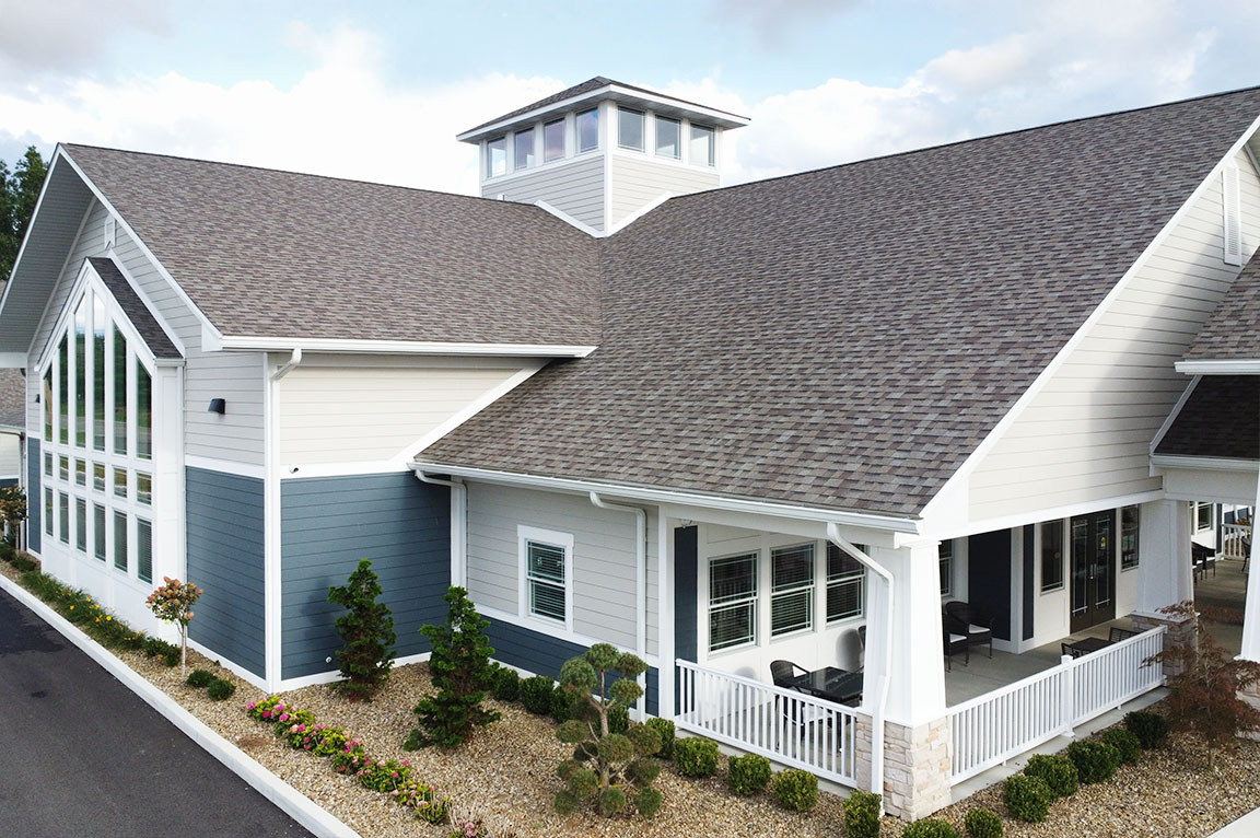 Commercial building exterior with covered porch and energy-efficient windows.