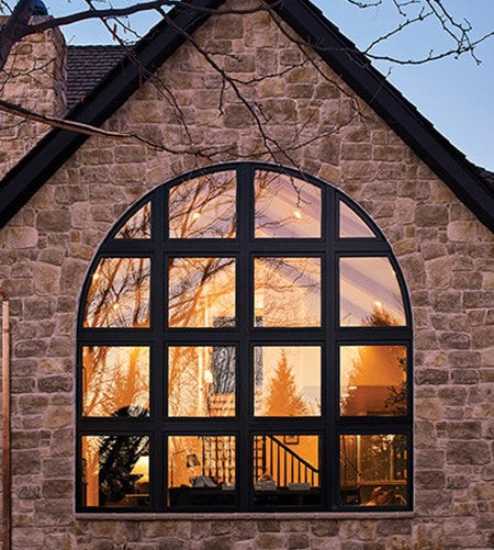 brick home exterior large arched custom window