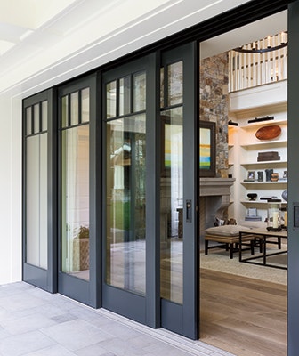 expansive multi-slide patio door with polished concrete floors and black trim