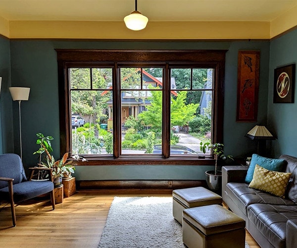 the interior view of three casement windows with top row grilles looking out onto the street outside
