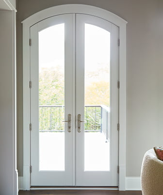 white architect series hinged patio door with arched top interior view