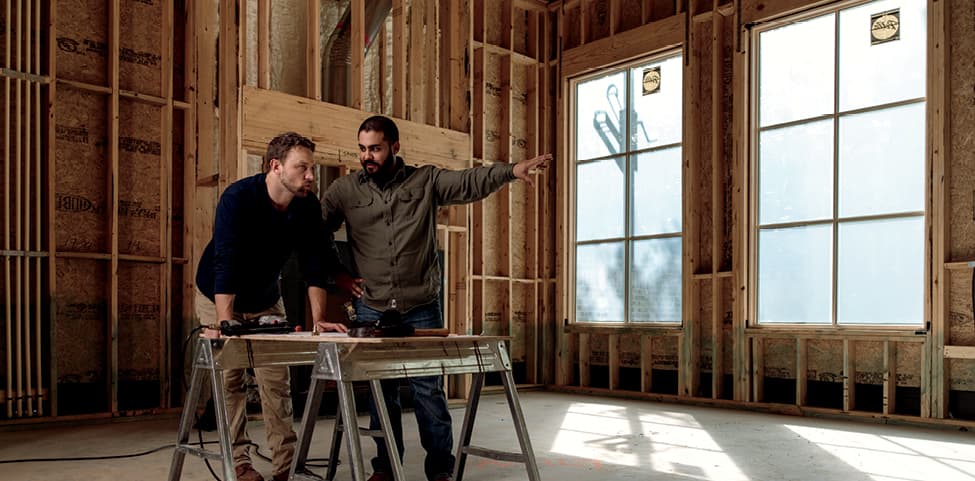 two contractors working in a home under construction