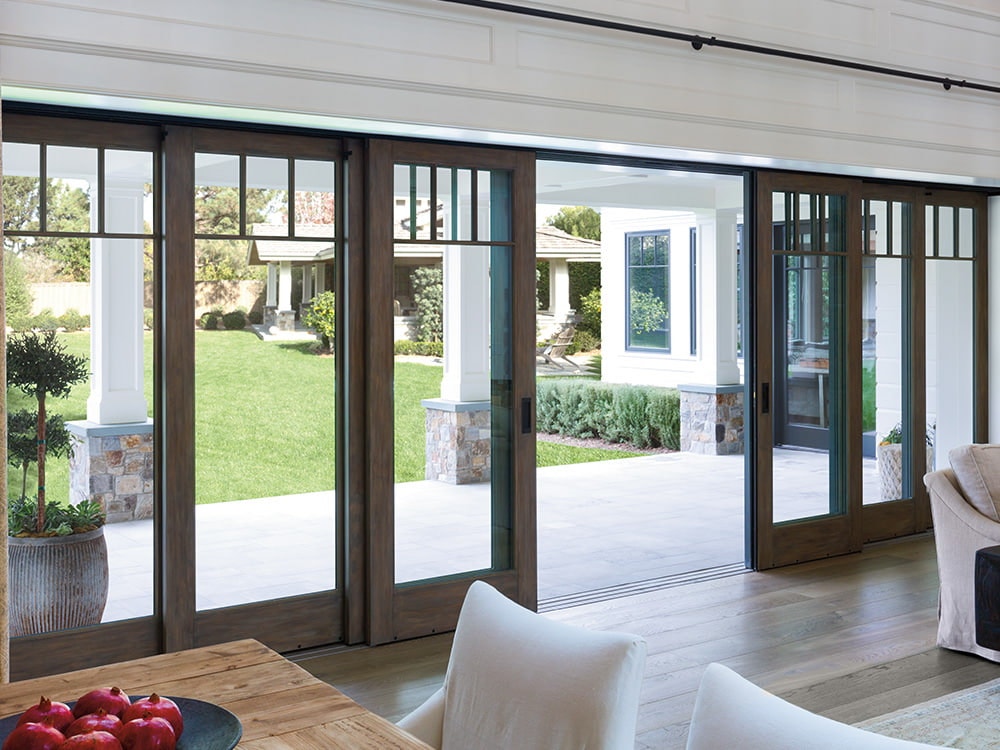 a 6-paneled multi-slide patio door bring the outdoors inside to a contemporary living room