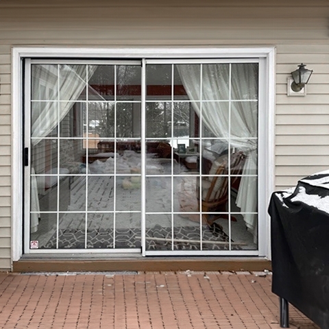 Outdated sliding patio door on Burlington home in need of replacement.