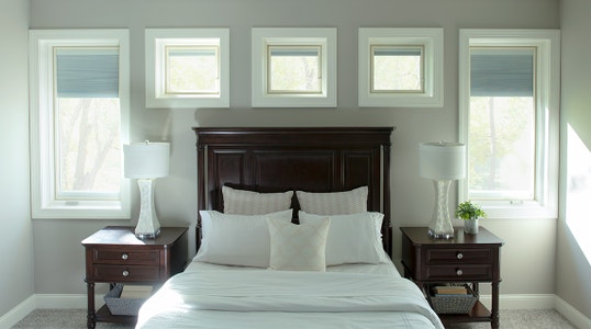 bedroom with lifestyle series casement windows surrounding the headboard