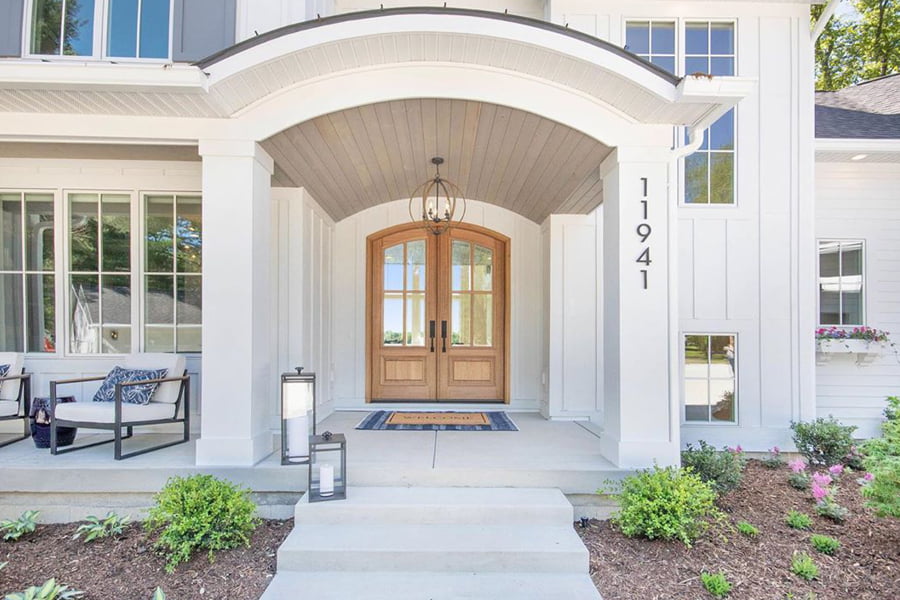 White Sherwood Homes with double wood entry doors