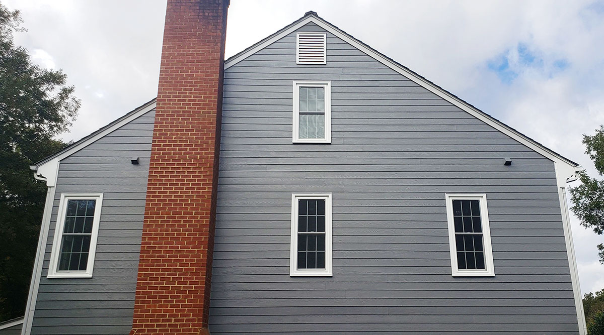 Exterior backside view of a Richmond Colonial home with newly installed vinyl windows.