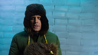 a man is wearing a warm winter hat but is still cold