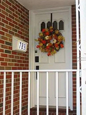 an outdated white door on a brick home