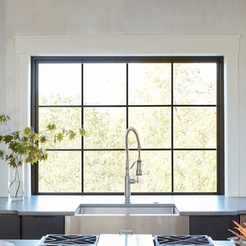 Black picture window over the kitchen sink