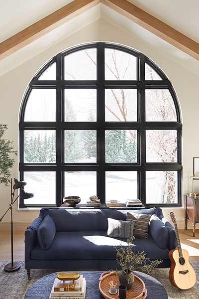 large cathedral ceiling with expansive arched black contemporary window