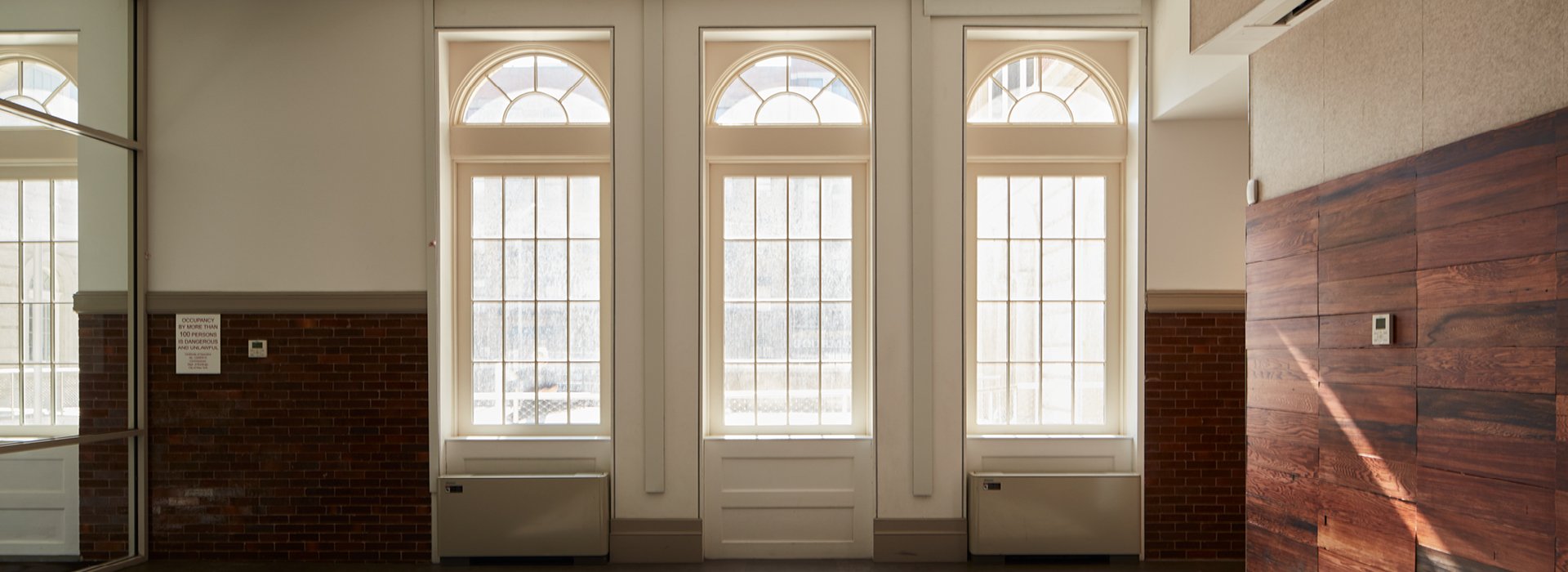 three pella reserve windows with arched transoms over each