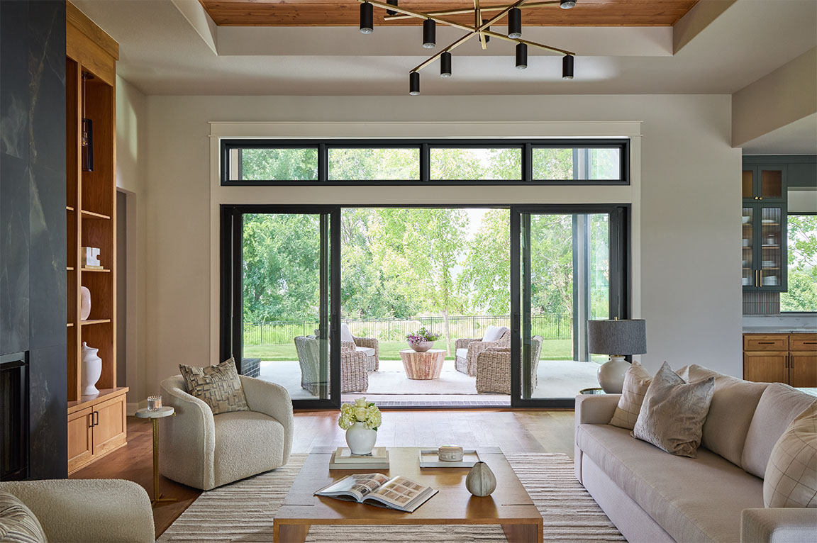 Modern living room with large sliding glass doors opening to an outdoor patio.