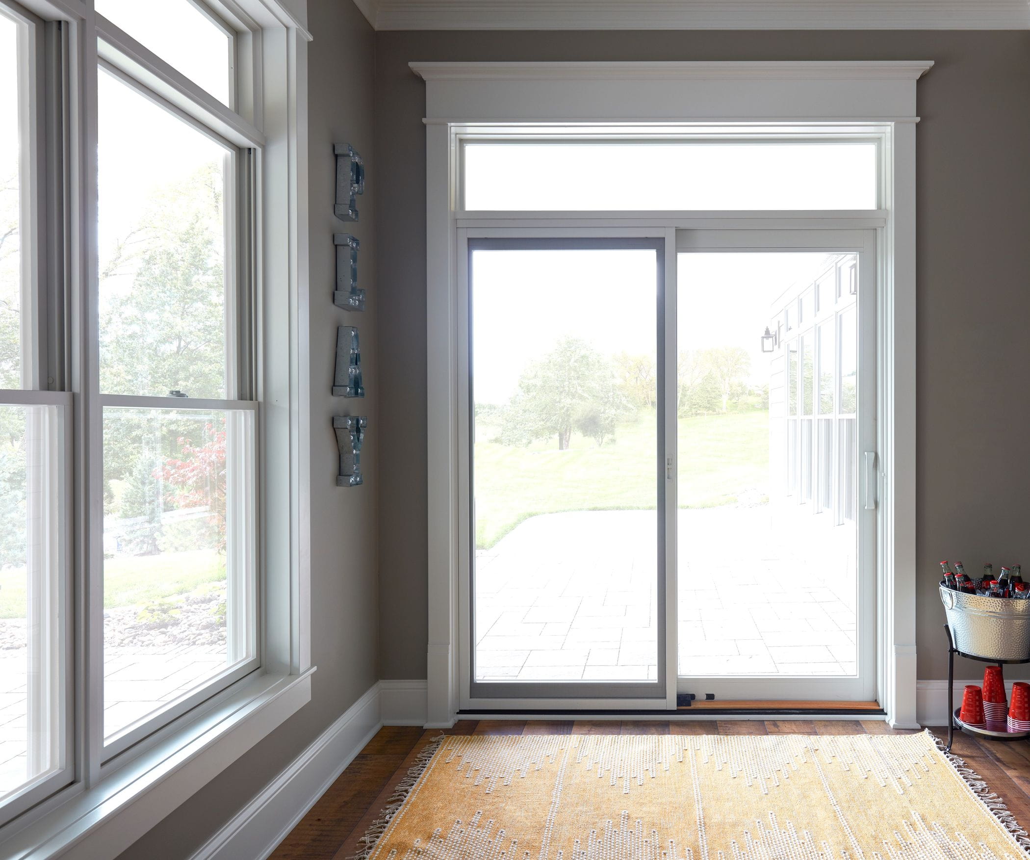A white sliding glass patio door in a sunroom