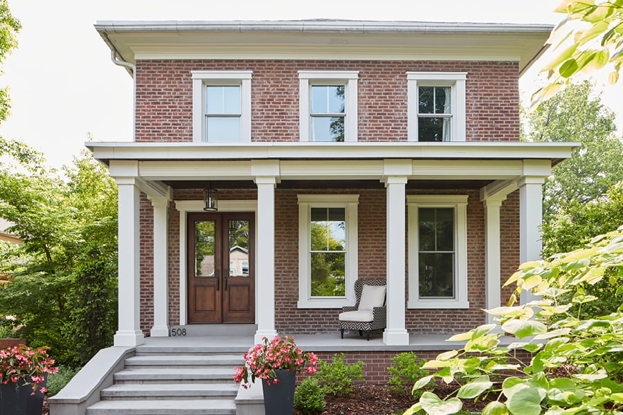 Two Story Traditional Colonial with Wood Entry Door, white trimming and patio