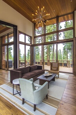 Rustic living room with floor-to-ceiling windows and multi-slide patio door