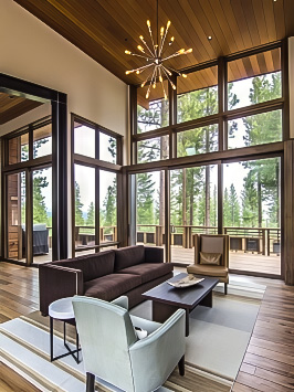 Rustic living room with floor-to-ceiling windows and multi-slide patio door