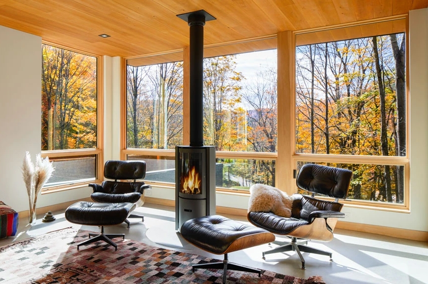 Interior image of a modern guesthouse highlighting the Mad River nature through newly installed Pella windows.