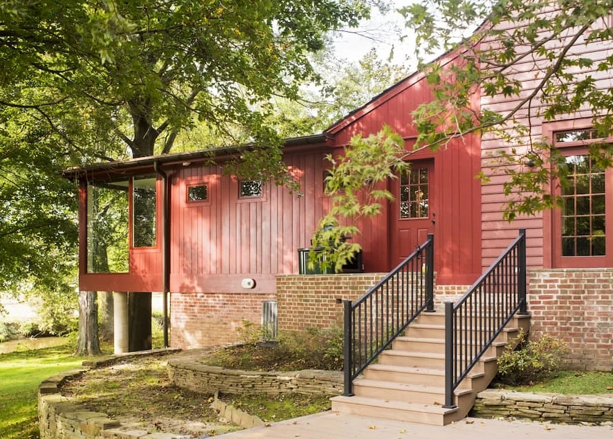 Sideview of Strasburg traditional home highlighting custom wood windows and side door.