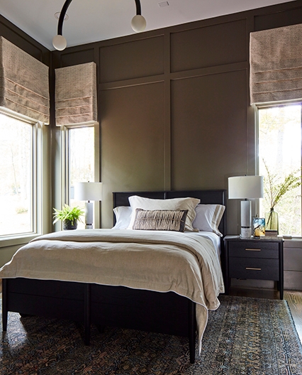 Bedroom windows shining lots of sunlight into space. 