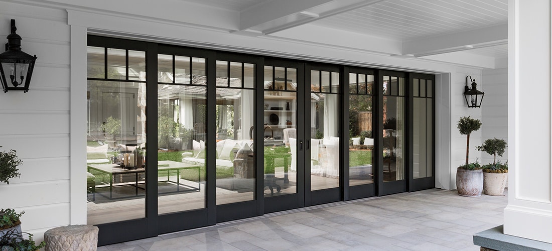 expansive black wood architect series traditional multi-slide patio door as viewed from the exterior